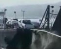 Une voiture attachée à une corde tombe d'un ferry